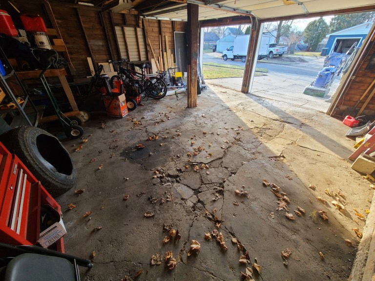 Before Picture of a Damaged Garage Floor